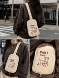 Ivory nylon crossbody sling bag with 'Petit i Eixerit' embroidery — Steve & Co. Explorer Sling Bag